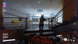 A player in The Finals follows their squadmates up a set of stairs in an office building.