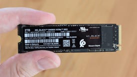 The WD Black SN850X SSD, being held between a finger and thumb.